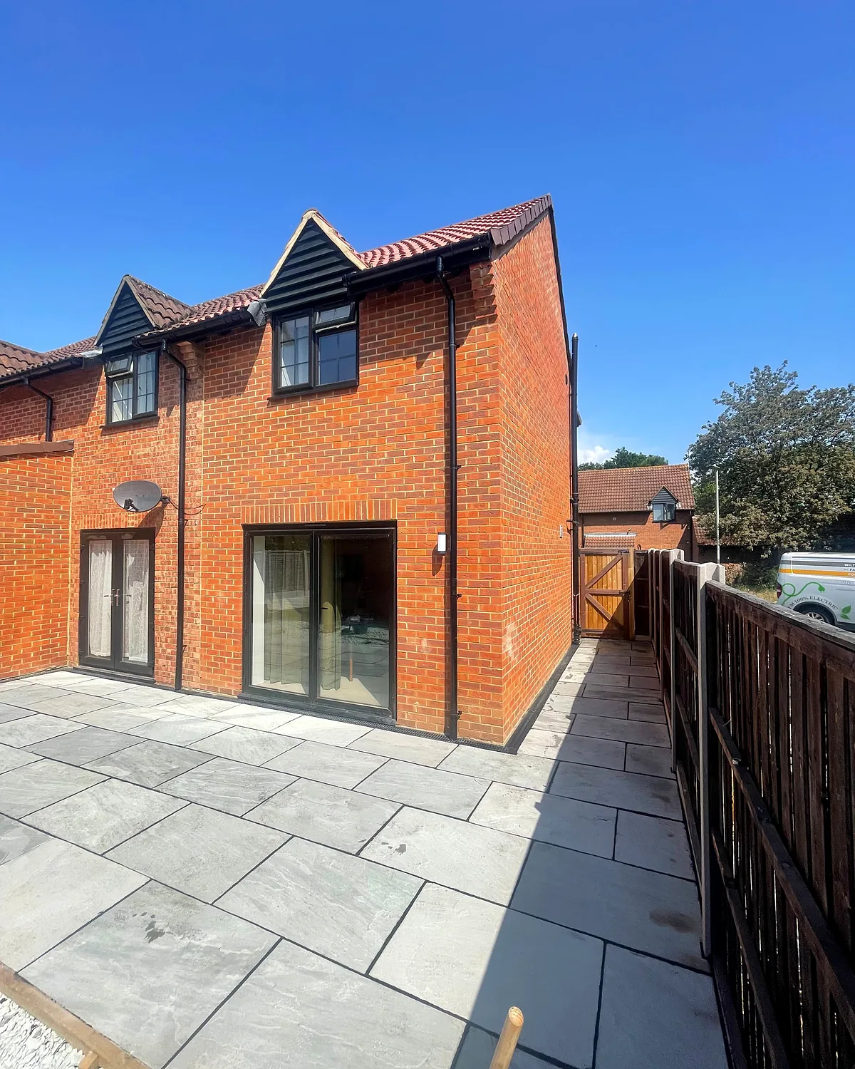 Patios, lawn and paving around new extensions