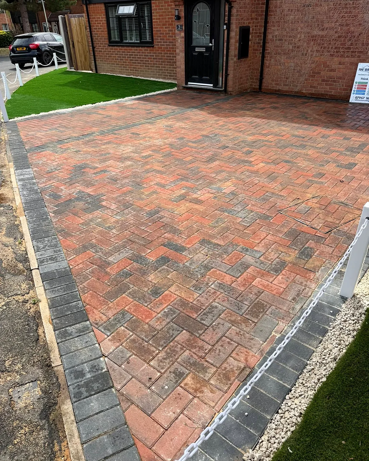 Red block paving with a grey border
