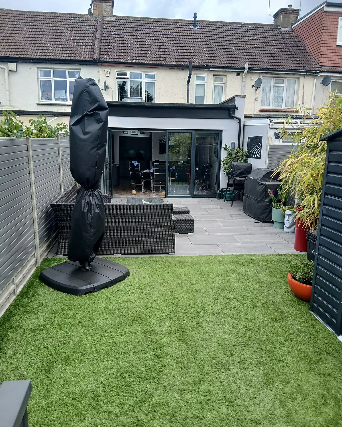 Porcelain patio and lawn behind a rear extension
