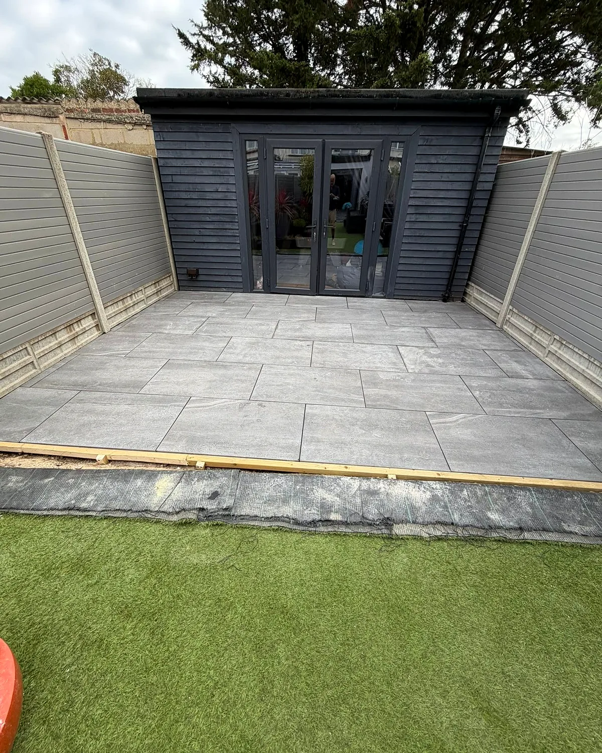 Patio and lawn in front of the garden room