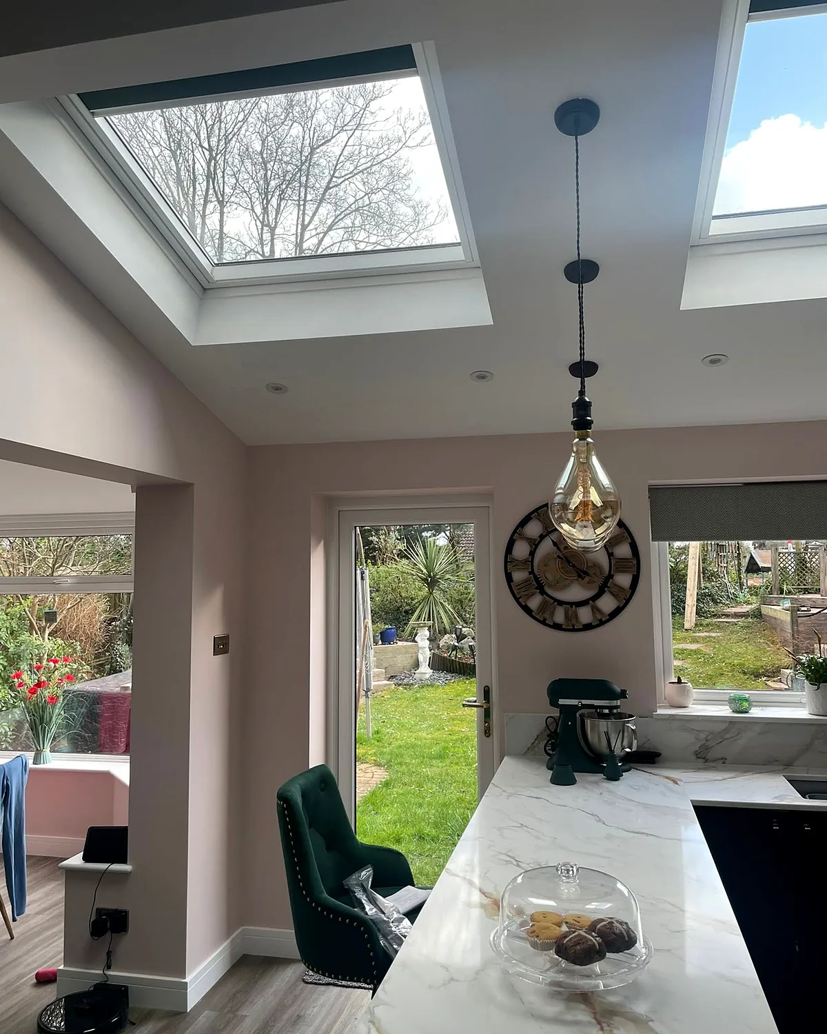 The kitchen: The finished kitchen under the rooflights, garden through the new doors.